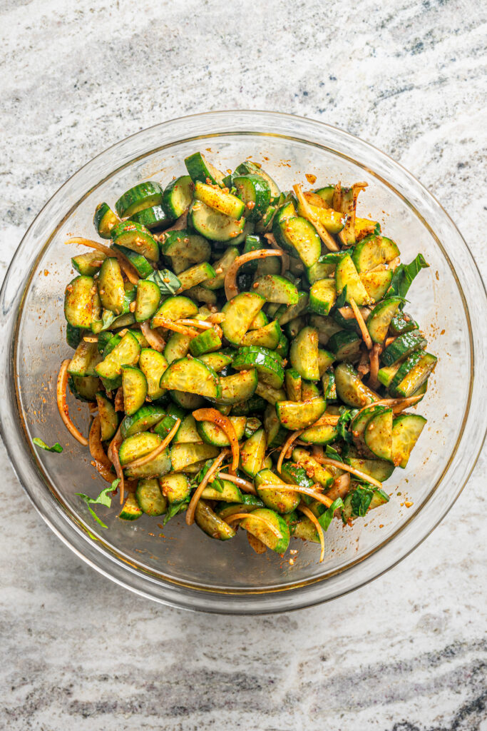 This easy cucumber kimchi recipe with gochugaru pepper and tangy fish sauce is the fastest way to put Korean kimchi on the table for dinner. Fermented kimchi in a bowl ready to be served.
