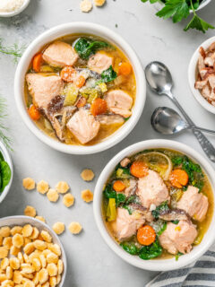 Poached salmon soup in bowls.