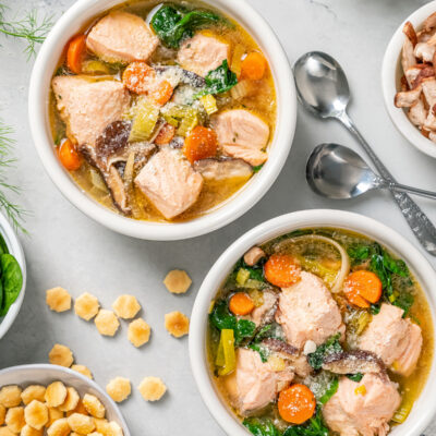 Poached salmon soup in bowls.