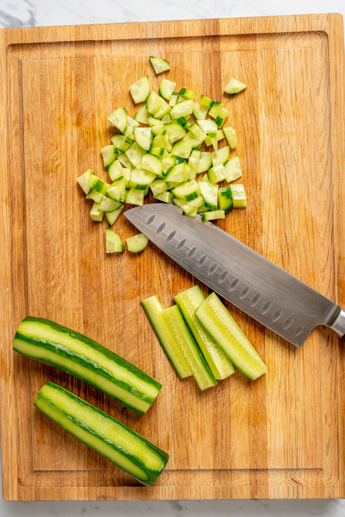 This quick shirazi salad with cucumbers, tomatoes, red onions, and a light vinaigrette is a refreshing Middle Eastern side you'll love. Dicing the tomatoes.