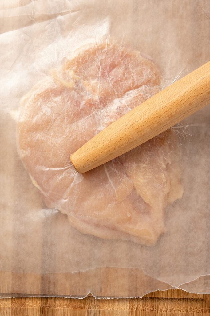 Stuffed Chicken Breasts pack so much flavor in every bite! With goat cheese, basil and white wine mushroom sauce, it's fancy but easy to make. Flattening a chicken breast between sheets of wax paper.