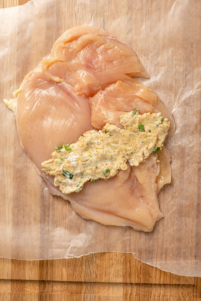 Stuffed Chicken Breasts pack so much flavor in every bite! With goat cheese, basil and white wine mushroom sauce, it's fancy but easy to make. Filling spooned across a flattened chicken breast.