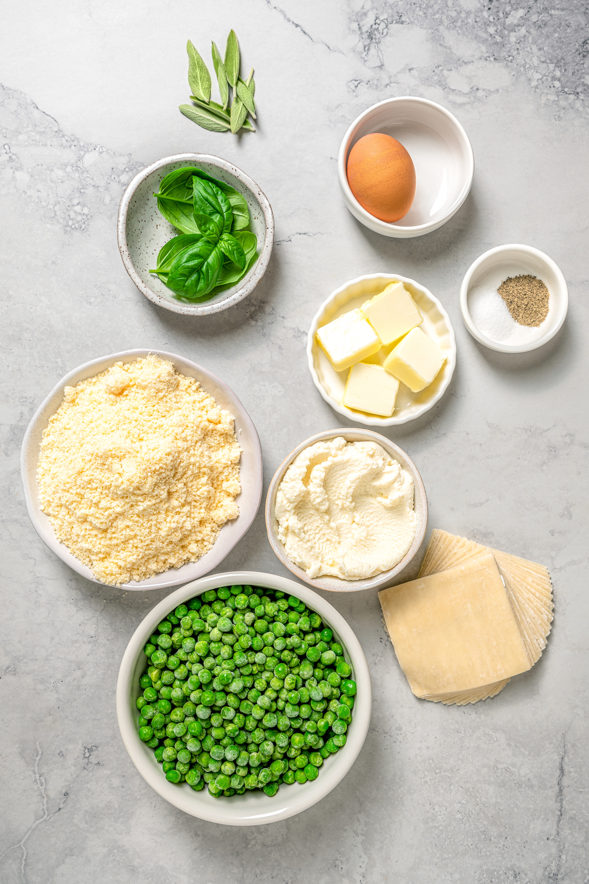 Cheese Ravioli with Peas and Butter Sauce will soon become one of your family's favorites. Easy to make with wonton wrappers! Ingredients for sweet pea ravioli measured and arranged on a table.