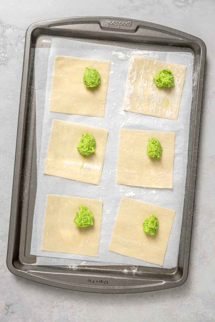 Cheese Ravioli with Peas and Butter Sauce will soon become one of your family's favorites. Easy to make with wonton wrappers! Adding a teaspoon of filling to each wonton wrapper.