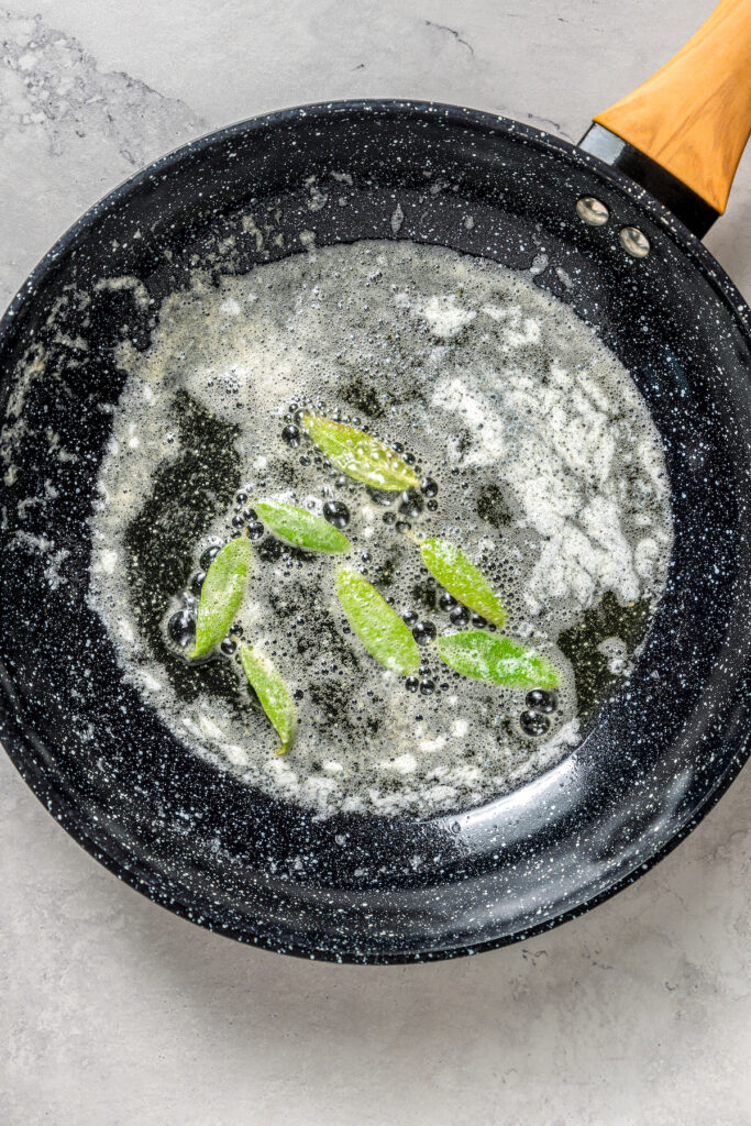 Cheese Ravioli with Peas and Butter Sauce will soon become one of your family's favorites. Easy to make with wonton wrappers! Butter and sage in a skillet.