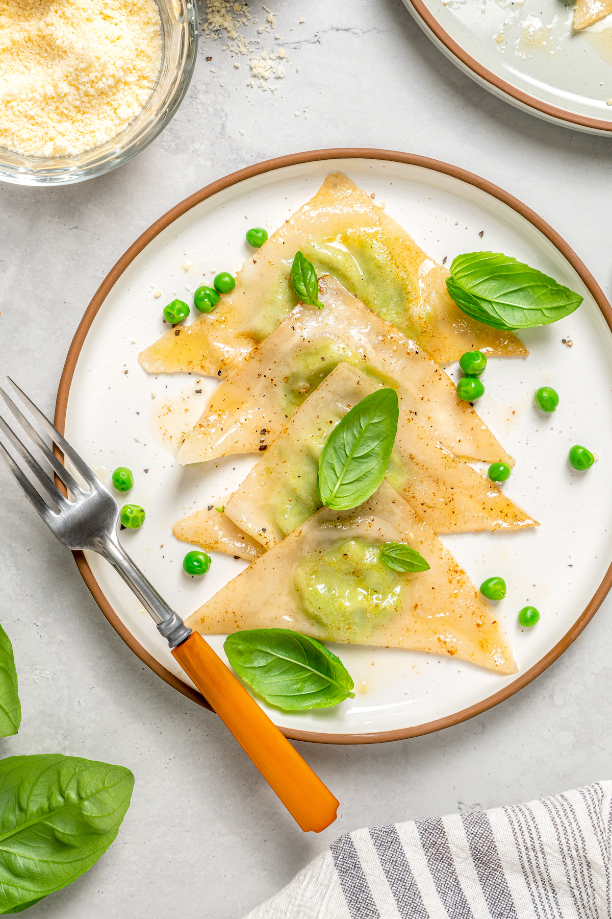 Cheese Ravioli with Peas and Butter Sauce will soon become one of your family's favorites. Easy to make with wonton wrappers! A plate of homemade wonton ravioli.