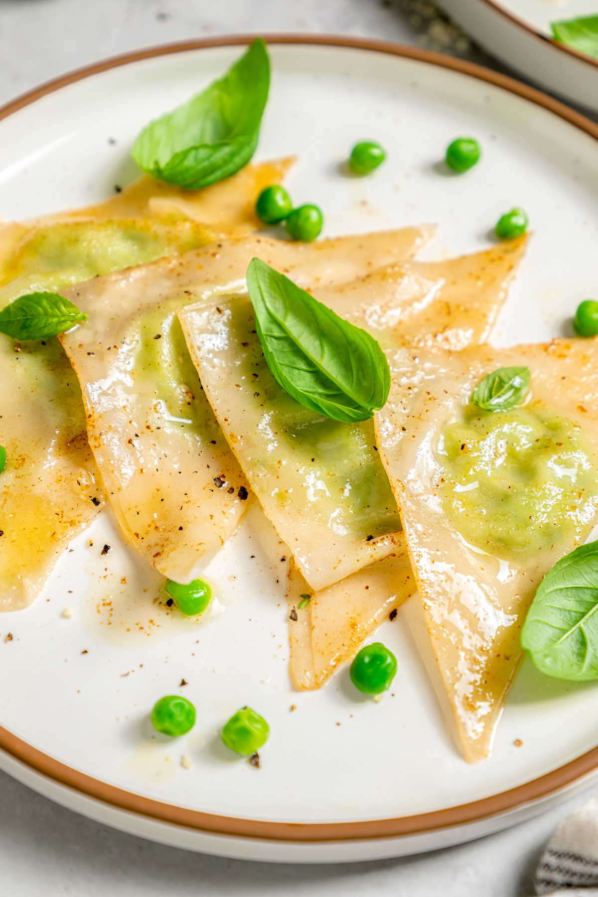 Cheese Ravioli with Peas and Butter Sauce will soon become one of your family's favorites. Easy to make with wonton wrappers! Four homemade ravioli made with wonton wrappers.