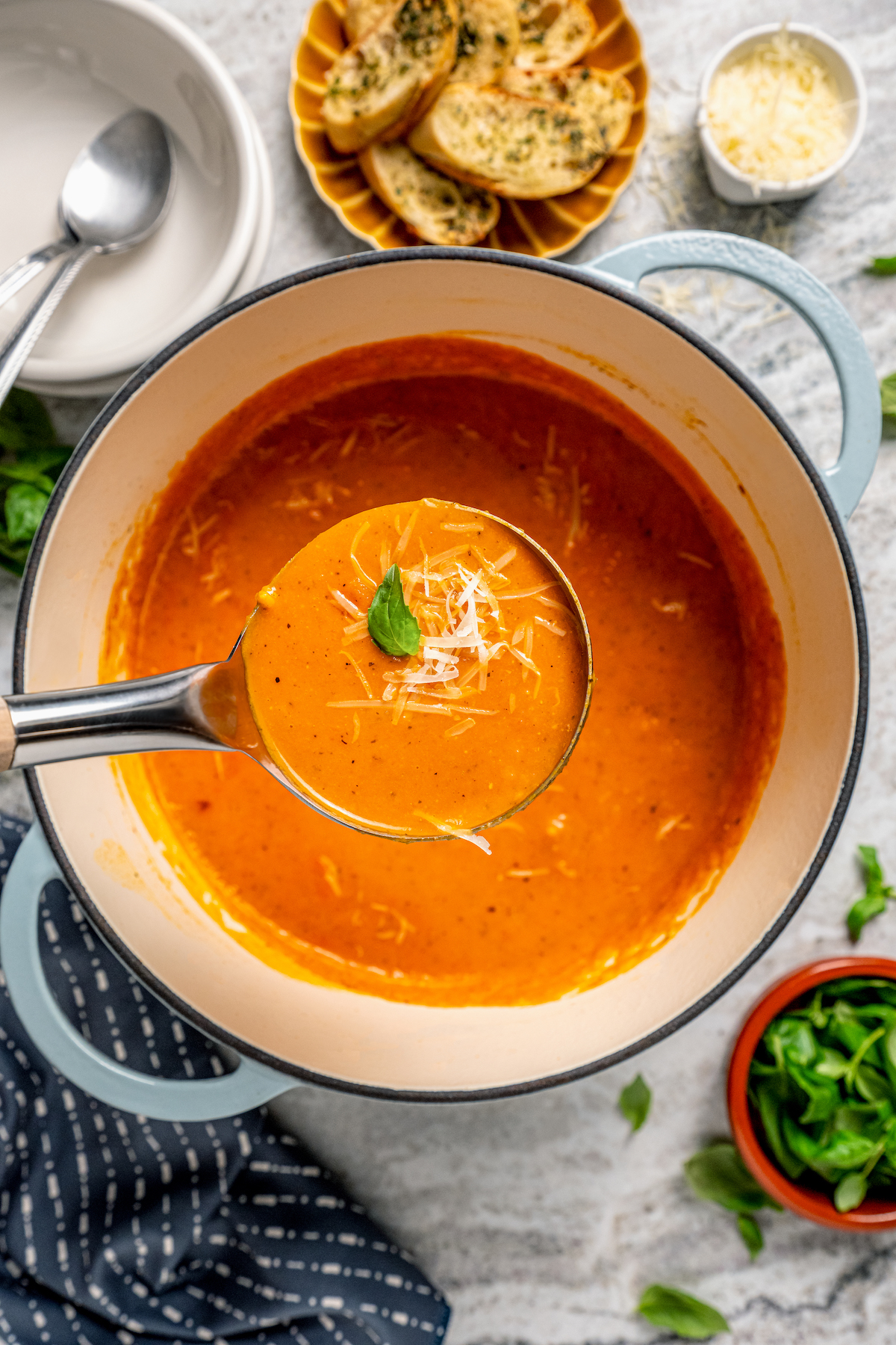 This easy tomato bisque recipe with parmesan and Italian seasoning is a comforting weeknight dinner paired with toasty sliced bread. Spoonful of creamy tomato bisque.