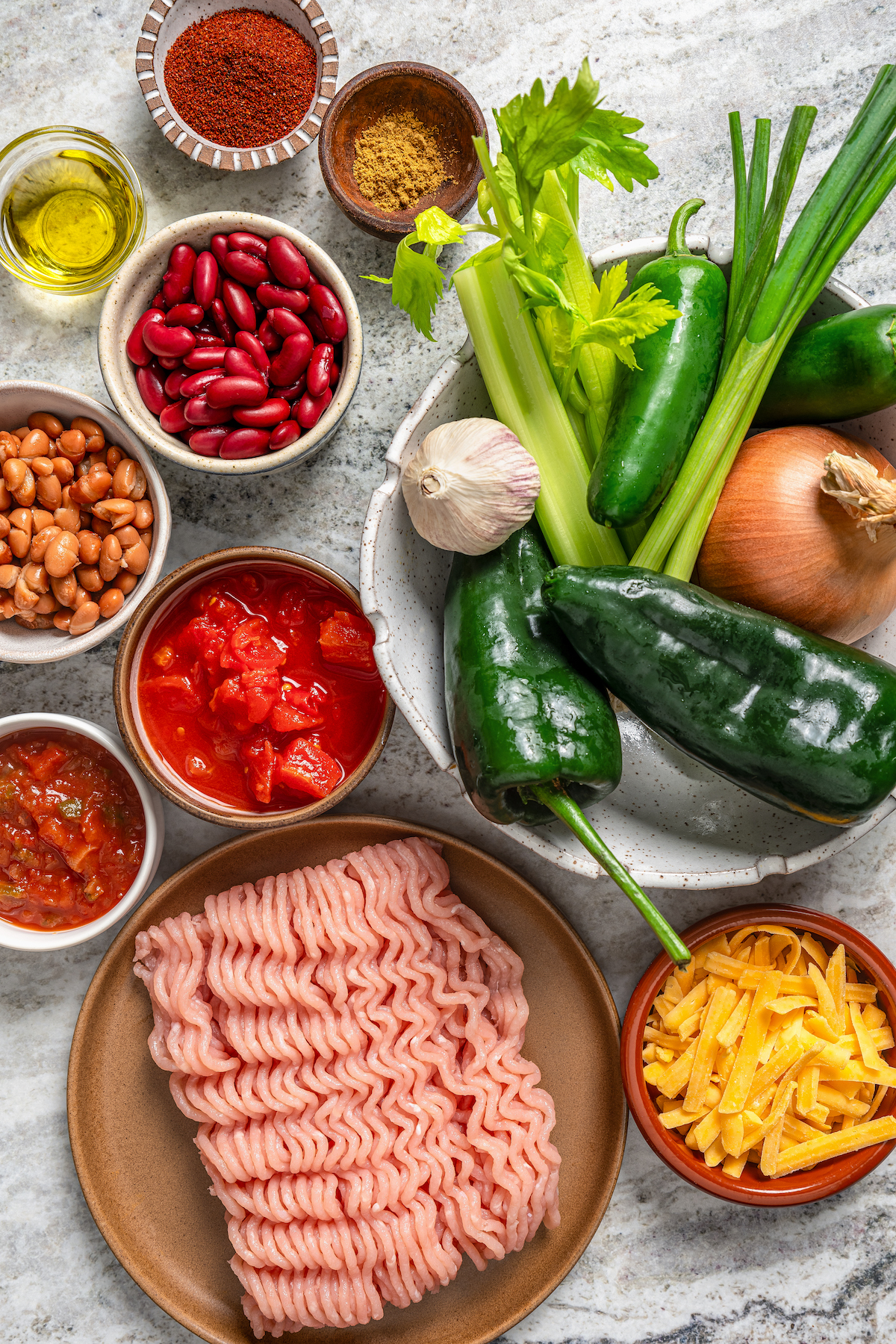 This freezer-friendly turkey chili recipe with beans, bell peppers, onions, and tomatoes is a smokey and spicy Tex-Mex weeknight dinner. Ingredients for turkey chili.