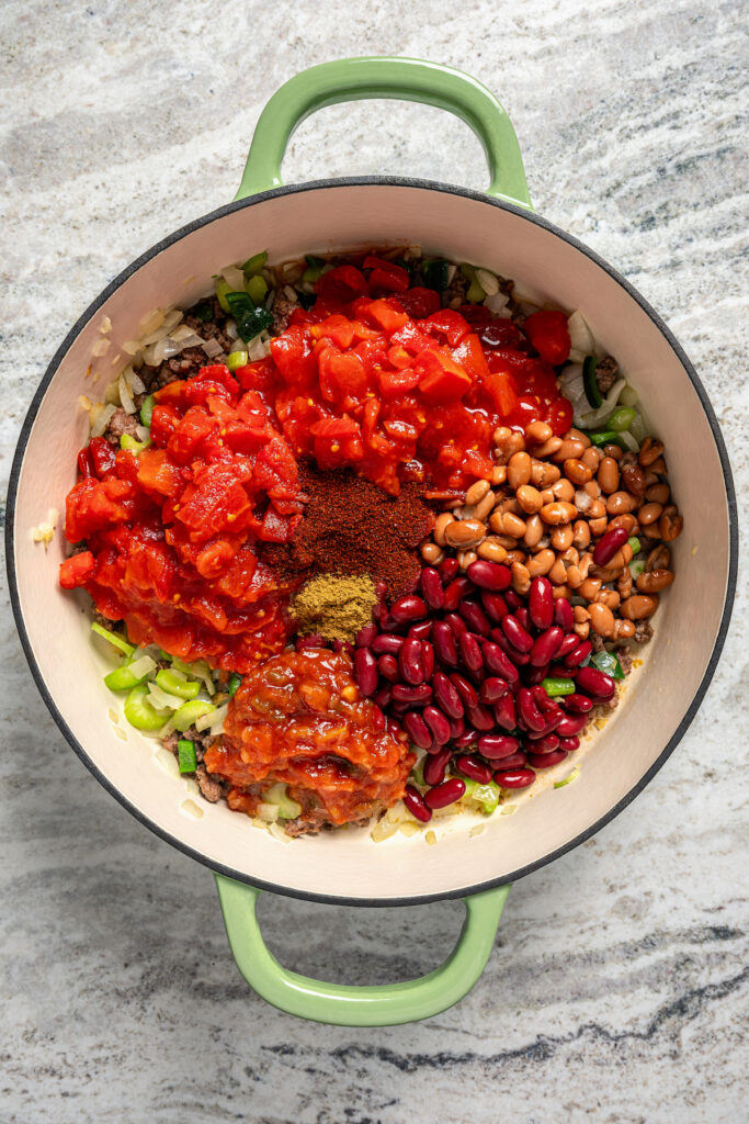 This freezer-friendly turkey chili recipe with beans, bell peppers, onions, and tomatoes is a smokey and spicy Tex-Mex weeknight dinner. Stirring in the tomatoes, beans, cumin, chili powder, and remaining ingredients.